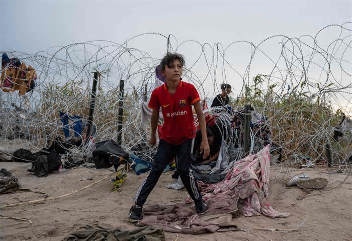 September 25, 2023: Chelsea from Nicaragua looks on after crawling through a hole made in the razor wire to cross into Eagle Pass, Texas. Dozens of migrants arrived at the US-Mexico border on Sept. 22, 2023, hoping to be allowed into the United States, with US border forces reporting 1.8 million encounters with migrants in the last 12 months.
