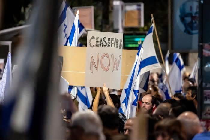 Israeli demonstrators hold signs and flags during an anti-government protest in Jerusalem on November 4, 2023. AFP