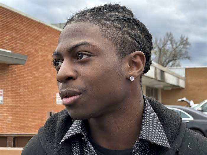 Darryl George, an 18-year-old high school junior, stands outside a courthouse in Anahuac, Texas, on Wednesday, Jan. 24, 2024. A judge ordered Wednesday that a trial be held next month to determine whether George can continue being punished by his district for refusing to change a hairstyle he and his family say is protected by a new state law. (AP Photo/Juan A. Lozano)