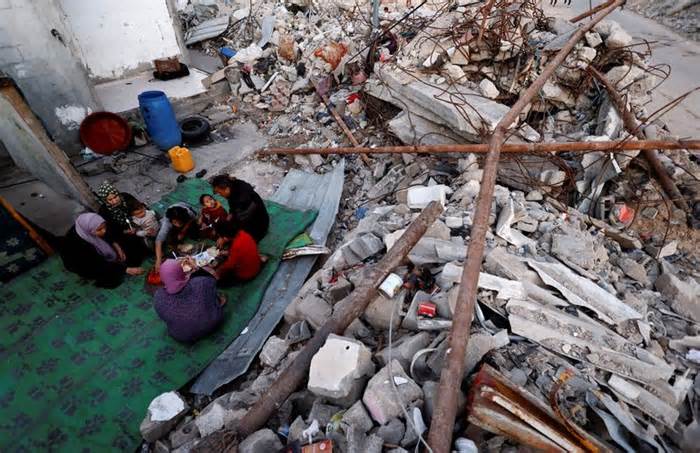 Palestinians break their fast amid the rubble of their destroyed home during Ramadan, in Rafah