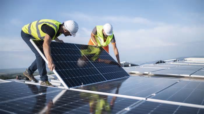 workers installing solar panels