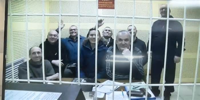 Eight of nine members of the Jehovah's Witnesses sentenced to prison on Tuesday are seen here posing for a photo in a Russian courtroom in April.
