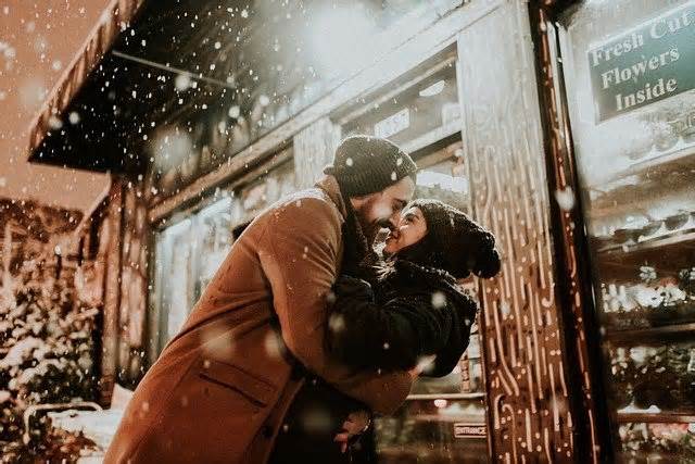 Couple hugging in snow