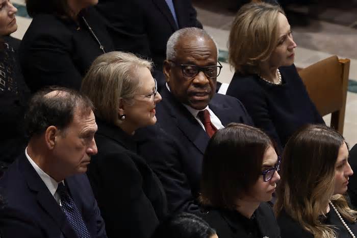 Justice Clarence Thomas (2nd R) talks with his wife Virginia Thomas as they and Justice Samuel Alito, Jr. (L) attend the funeral service for late retired Supreme Court Justice Sandra Day O’Connor at Washington National Cathedral on December 19, 2023 in Washington, DC.
