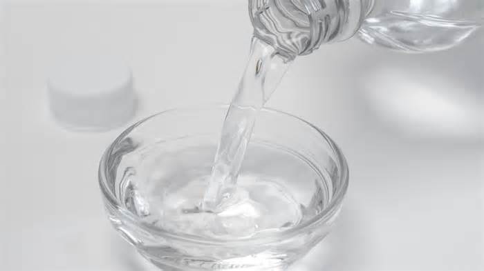 Pouring distilled white vinegar