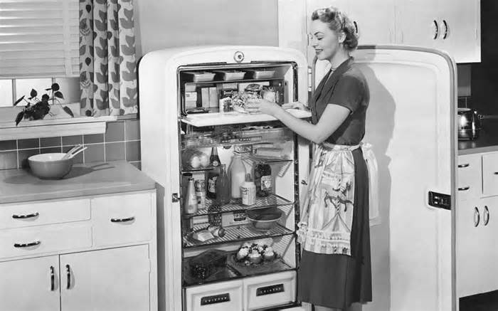 Woman with open refrigerator