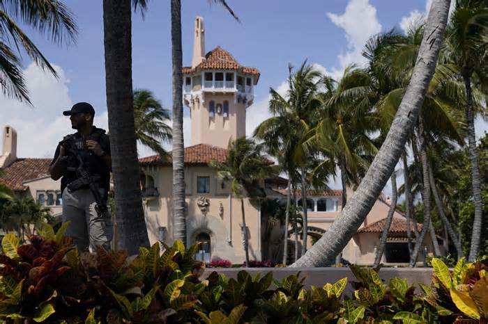 FILE - A security guard stands on the perimeter of former President Donald Trump's Mar-a-Lago home, Monday, April 3, 2023, in Palm Beach, Fla., a day before he travels to New York for his arraignment on charges related to hush money payments. Within days, Trump could potentially have his sprawling real estate business empire ordered “dissolved” for repeated misrepresentations on financial statements to lenders, adding him to a short list of scam marketers, con artists and others who have been hit with the ultimate punishment for violating New York’s powerful anti-fraud law. (AP Photo/Evan Vucci, File)