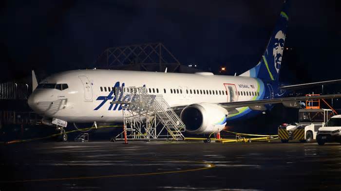 A plastic sheet covers an area of the fuselage of the Alaska Airlines N704AL Boeing 737 MAX 9 aircraft outside a hangar at Portland International Airport on January 8, 2024 in Portland, Oregon. NTSB investigators are continuing their inspection on the Alaska Airlines N704AL Boeing 737 MAX 9 aircraft following a midair fuselage blowout on Friday, January 5. None of the 171 passengers and six crew members were seriously injured.