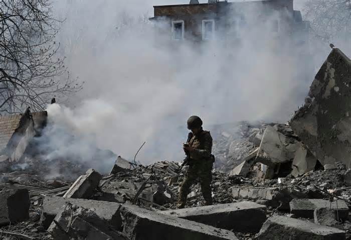 A member of the Ukrainian White Angels Special Police Team walks amongst the debris of a multi-storey residential building, destroyed following an air strike in the frontline town of Avdiivka, Donetsk region on April 10, 2023, amid the Russian invasion of Ukraine. (Photo by Genya SAVILOV / AFP) (Photo by GENYA SAVILOV/AFP via Getty Images)