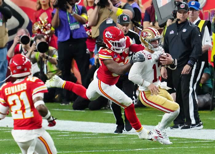 San Francisco 49ers quarterback Brock Purdy (13) is tackled by Kansas City Chiefs linebacker Nick Bolton (32) in the first half in Super Bowl LVIII at Allegiant Stadium.