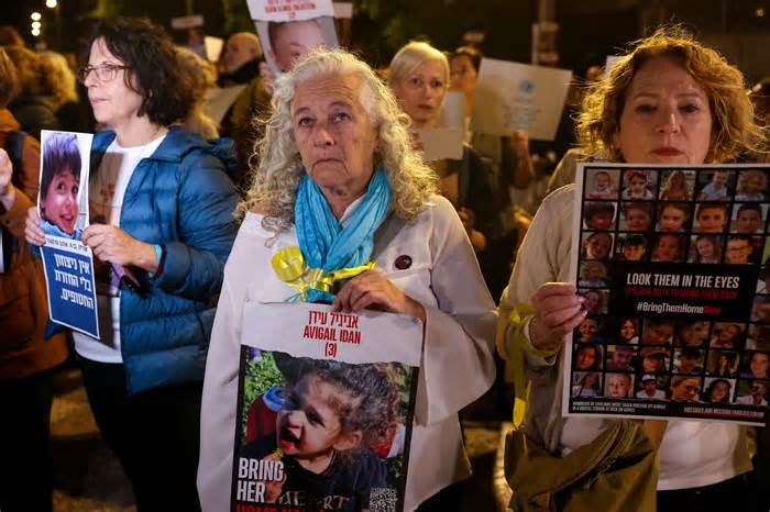 A woman holds a portrait of Avigail Idan, 3, as protesters lift placards during a rally outside the Unicef offices in Tel Aviv on Nov. 20, 2023 to demand the release of Israelis held hostage in Gaza since the October 7 attack by Hamas militants, amid ongoing battles between Israel and the Palestinian armed group.