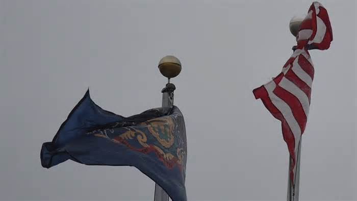 Flags whip as the wind picks up outside Emmaus High School during a storm Tuesday, Jan. 9 2024, in Emmaus.