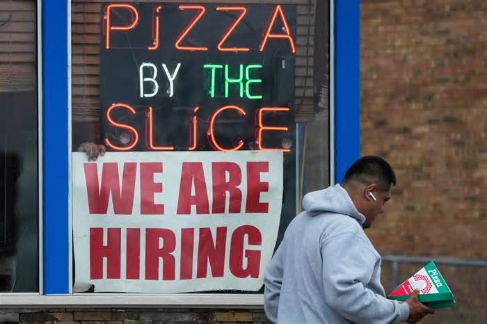 A hiring sign is displayed at a restaurant in Prospect Heights, Ill., on April 4, 2023.