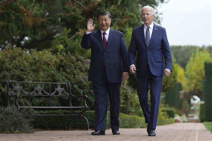 President Biden and Chinese leader Xi Jinping walk through the gardens of the Filoli estate in Woodside, Calif., on Wednesday.