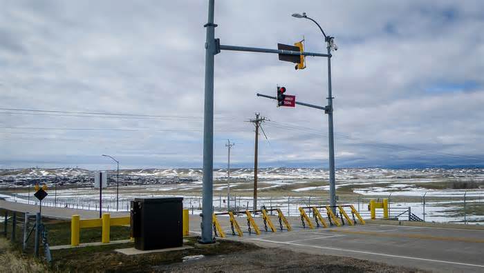 An emergency vehicle barrier stands at Ellsworth Air Force Base in Rapid City, S.D. A B-1 Lancer bomber from the base crashed Thursday, Jan. 4, 2024, with all four of its crew members ejecting, the Air Force said. (Arielle Zionts /Rapid City Journal via AP)
