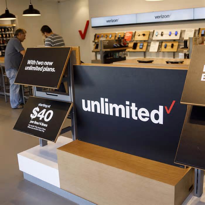 A sign for the Verizon Communications Inc. unlimited plan is displayed at a store in Brea, California, U.S., on Monday, Jan. 22, 2018.