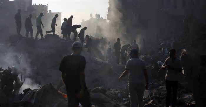 Civilians conduct search and rescue operations and debris removal work at the heavily damaged buildings after Israeli attacks at Al Bureij Refugee Camp as Israeli attacks continue on the 27th day in Gaza City, Gaza on November 02, 2023.