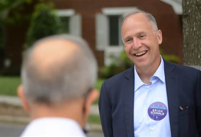Attorney Brian Schwalb campaigns at the Shepherd Elementary School pooling place during primary election day in Washington, on June 21, 2022.