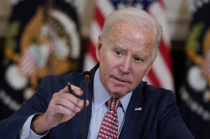 President Joe Biden adjusts his microphone during a meeting with the President's Council of Advisors on Science and Technology in the State Dining Room of the White House, Tuesday, April 4, 2023, in Washington. (AP Photo/Patrick Semansky) (Photo: via Associated Press)
