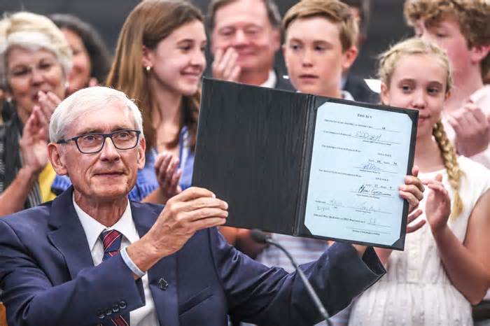 Gov. Tony Evers shows the 2021-23 biennial budget now known as 2021 Wisconsin Act 58 after signing it Thursday, July 8, 2021, at Cumberland Elementary School located at 4780 N. Marlborough Dr., Whitefish Bay, Wis. The bill provides one of the largest tax cuts in Wisconsin's history. Gov. Evers also announced a $100 million in new funding for public schools included in the biennial budget. Ebony Cox / Milwaukee Journal Sentinel
