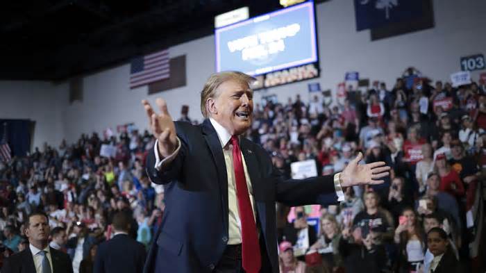 Republican presidential candidate and former President Donald Trump gestures to members of the audience as he leaves a rally at Coastal Carolina University on February 10, 2024, in Conway, South Carolina.