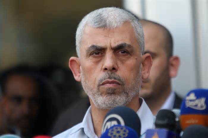 Yahya Sinwar looks on as Ismail Haniyeh (unseen) speaks to the press upon the latter's arrival on the Palestinian side of the Rafah border crossing, in the southern Gaza Strip on September 19, 2017