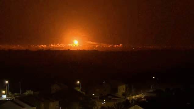 Explosion and flares over night Gaza skyline
