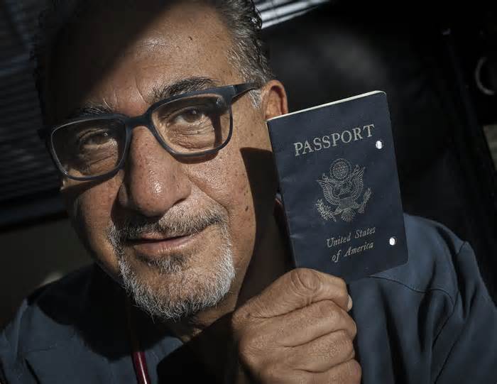 Siavash Sobhani holds one of his expired passports.