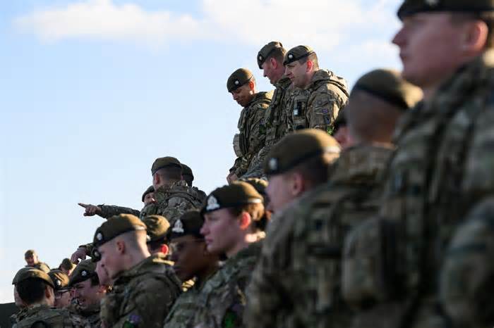 OAKHAM, ENGLAND - JANUARY 26: Soldiers from the 2nd Battalion The Royal Anglian Regiment, also known as 'The Poachers', gather for a group photo during a media visit to Kendrew Barracks on January 26, 2024 near Oakham, England. As part of continuing preparations, the Spearhead Battalion were practicing short notice deployment drills, in their role as the infantry core of NATO's Spearhead Battlegroup. The 2nd Battalion The Royal Anglian Regiment, also known as 'The Poachers', are participating in the exercise Polish Dragon in March, part of the months-long NATO Steadfast Defender exercises across Europe. (Photo by Leon Neal/Getty Images)