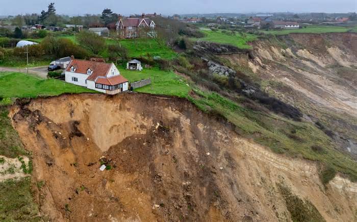 Old farmhouse at Cliff Farm in Trimingham, which dates back to the 18th century, is dangling over the cliffs