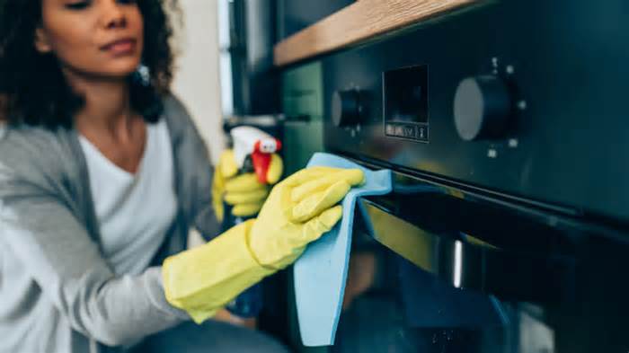 Woman cleaning an oven