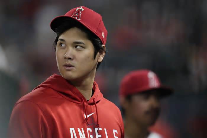 FILE - Los Angeles Angels' Shohei Ohtani walks in the dugout during the ninth inning of the team's baseball game against the Detroit Tigers in Anaheim, Calif., Sept. 16, 2023. Ohtani, Cody Bellinger, Jordan Montgomery, Blake Snell and Aaron Nola were among the 130 players who became free agents Thursday, Nov. 2, as baseball's business season began the day following the Texas Rangers' first World Series title. Max Muncy, Joe Jiménez and Colin Rea gave up a chance to go free and agreed to new contracts with their teams. (AP Photo/Ashley Landis, File)
