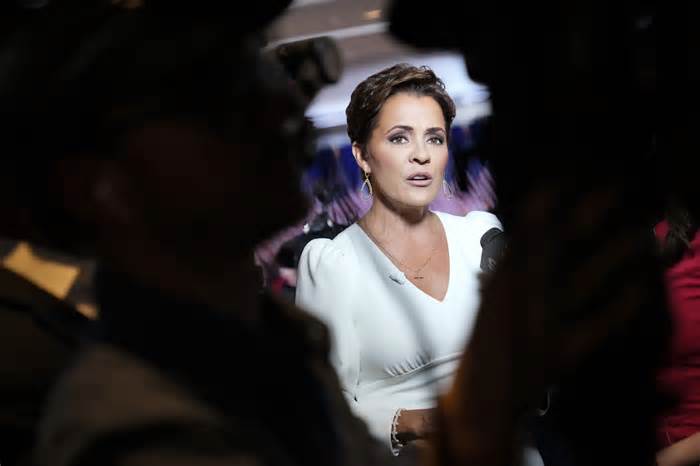 Kari Lake speaks during a television interview before Republican presidential candidate former President Donald Trump arrives at a primary election night party in Nashua, N.H., on Jan. 23, 2024.