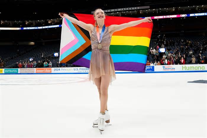 Jan 26, 2024; Columbus, Ohio, USA; Amber Glenn takes a victory lap around the rink following the championship women medal ceremony during the 2024 US Figure Skating Championships at Nationwide Arena. Mandatory Credit: Adam Cairns-USA TODAY Sports