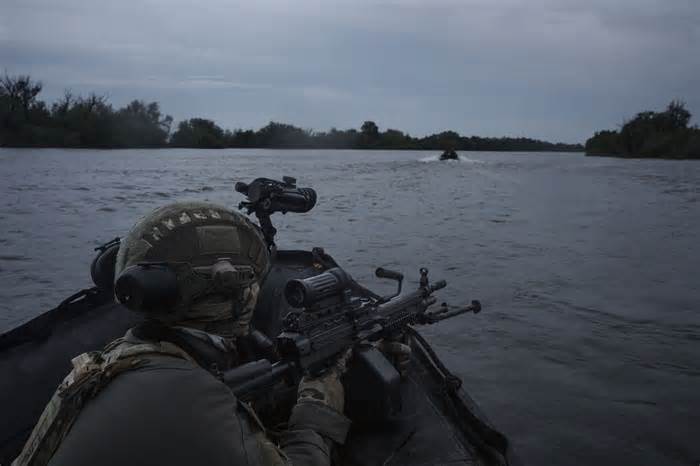 Ukrainian soldiers navigate on the Dnipro river by boat at the frontline near Kherson, Ukraine, Sunday, June 11, 2023. (AP Photo/Felipe Dana)