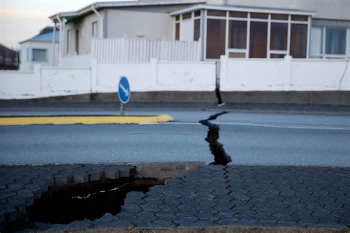A fissure stretches across a road in the town of Grindavik