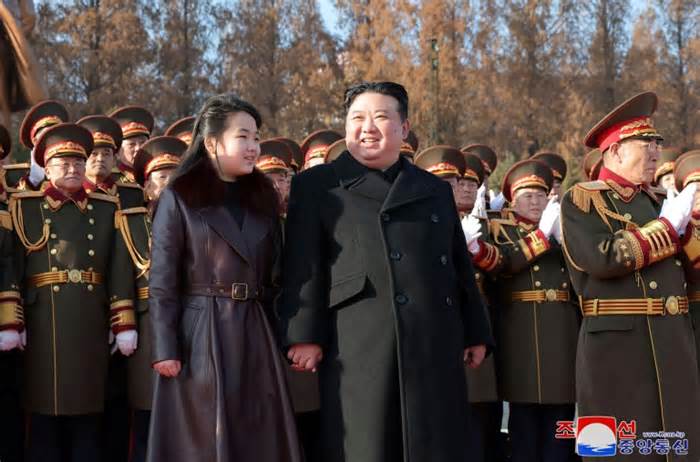 An image released by North Korea's official KCNA shows Kim Jong Un (C) holding hands with his daughter, Ju Ae, who some analysts say is being groomed as the next leader