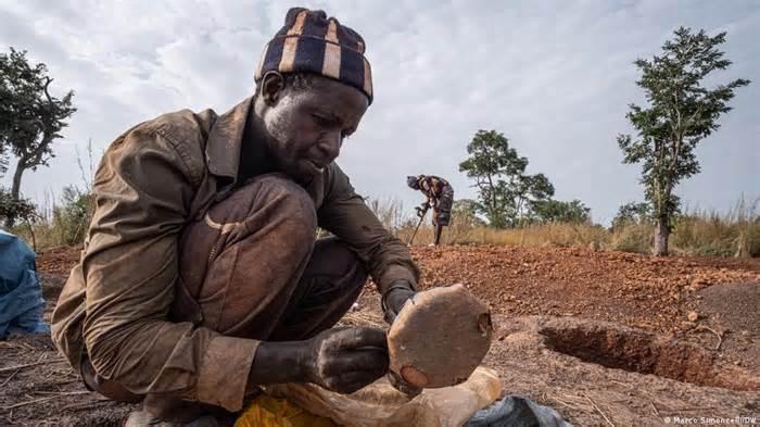 Mineiro prepara o seu detetor de metais numa floresta da zona rural de Kedougou