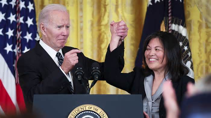 President Joe Biden links arms with Julie Su, his nominee to be the next Secretary of Labor during an event in the East Room of the White House March 1, 2023 in Washington, DC.