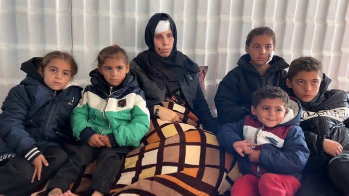 Nawara al-Najjar, sitting with some of her children, was injured by shrapnel that ripped into her tent on 12 February