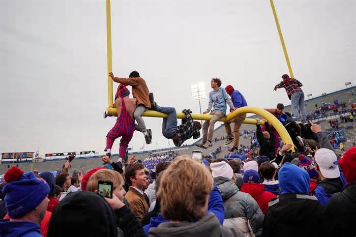 Kansas students climb on and tear down the goalpost after Kansas Jayhawks defeat the Oklahoma Sooners on Saturday. (Denny Medley-USA TODAY Sports)