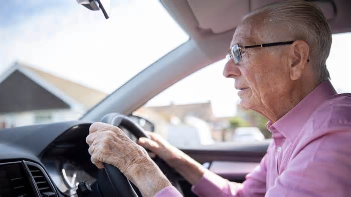 Worried Senior Male Driver Looking Through Car Windscreen