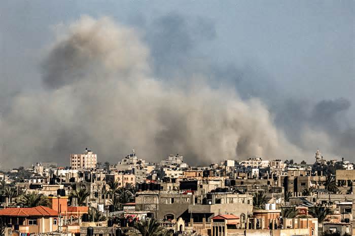 Smoke billows over Khan Yunis from Rafah in the southern Gaza strip during Israeli bombardment on Dec. 26, 2023, amid continuing battles between Israel and the Palestinian Hamas militant group.