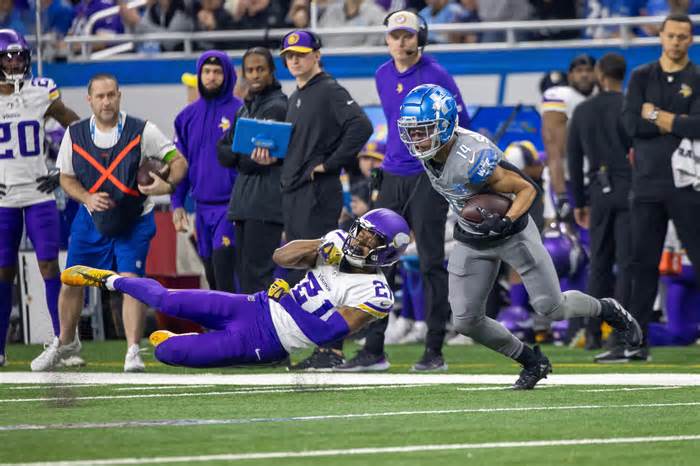 Detroit Lions wide receiver Amon-Ra St. Brown (14) catches a pass and shakes a tackle attempt by Minnesota Vikings cornerback Akayleb Evans (21) during first quarter at Ford Field.