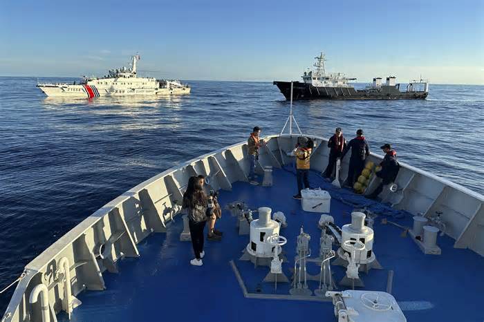 Chinese coast guard and suspected Chinese militia ship block the Philippine coast guard ship BRP Cabra as they approach Second Thomas Shoal, locally known as Ayungin Shoal, during a resupply mission at the disputed South China Sea on Friday Nov. 10, 2023. (AP Photo/Joeal Calupitan)