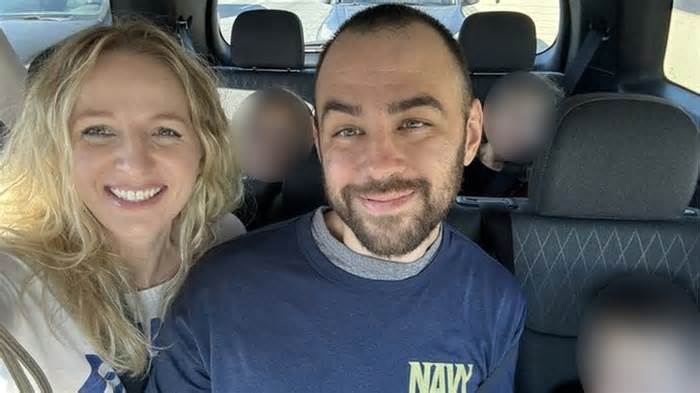 A photo of a smiling Ridge Alkonis sitting with his family in a car after his release