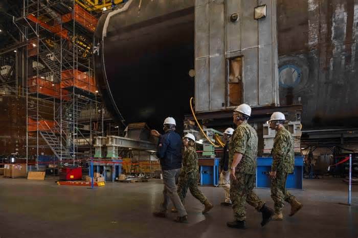 Then-Vice Chief of Naval Operations Adm. Lisa Franchetti meets with leadership from General Dynamics Electric Boat while touring the facility in Quonset Point, Rhode Island, on Oct. 19, 2023.