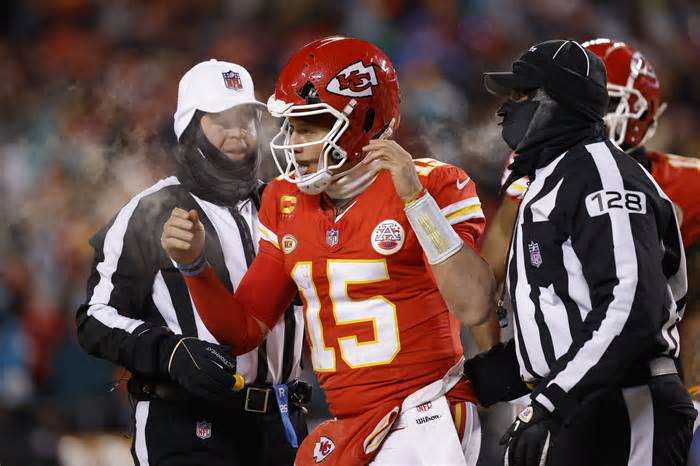 KANSAS CITY, MISSOURI - JANUARY 13: Patrick Mahomes #15 of the Kansas City Chiefs heads to the sideline after his helmet was cracked during the third quarter in the AFC Wild Card Playoffs against the Miami Dolphins at GEHA Field at Arrowhead Stadium on January 13, 2024 in Kansas City, Missouri. (Photo by David Eulitt/Getty Images)
