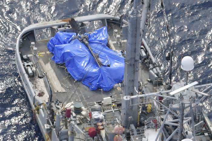 A blue sheet covers what believed to be a part of a crashed U.S. military Osprey aircraft on a U.S. salvage boat off Yakushima, Kagoshima prefecture, southern Japan on, Dec. 27, 2023. The U.S. Air Force on Friday, Jan. 12, 2024 announced the end of its more than a month long search and recovery operation at the site of a CV-22B Osprey crash that occurred off the southern Japanese coast in late November, expressing regret at not being able to find the last of the eight crew members killed. (Kyodo News via AP)
