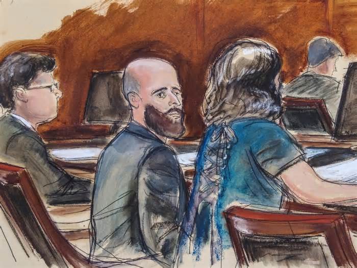In this courtroom sketch, Joshua Schulte, center, is seated at the defense table flanked by his attorneys during jury deliberations, Wednesday March 4, 2020, in New York.